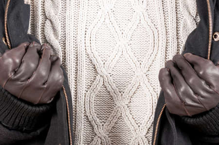 Close-up of warm jumper with jacket and gloves as knitwear style conceptの写真素材