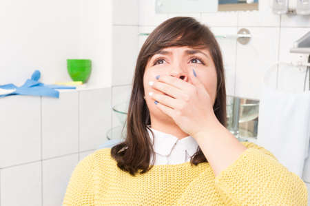 Woman in pain suffers from toothache in dentistry office require for a dental treatment