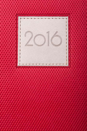Close-up of red diary or agenda with current year as planning memo concept