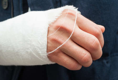 Closeup hand and fingers with white bandage as trauma or accident concept