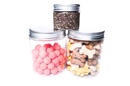 Animal or pet food dry in transparent jars isolated as presentation on white studio background