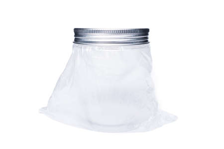 New transparent plastic jar or container with aluminum lid isolated on white studio background