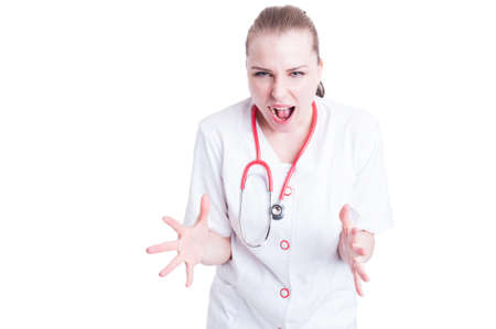 Young and nervous woman doctor with a stethoscope yell at you and show frustration and anger isolated on white backgroundの写真素材