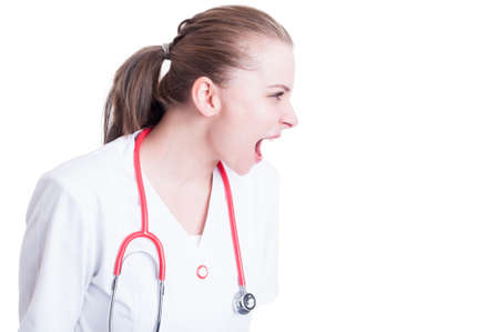 Stressed woman doctor screaming and showing rage and anxiety because of a problem with copyspaceの写真素材
