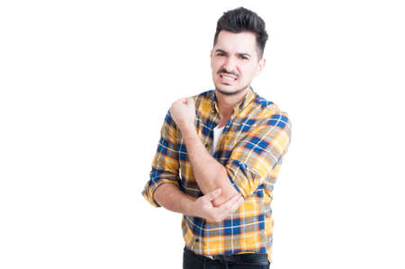 Handsome man suffering from elbow pain caused by rheumatism or trauma bone isolated on white backgroundの写真素材