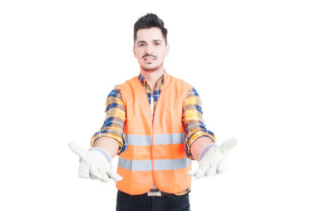Attractive constructor wearing protection equipment waiting to receive something while standing with...