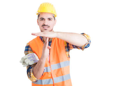 Handsome smiling engineer making a pause or time out gesture with hands as break concept isolated on white backgroundの写真素材