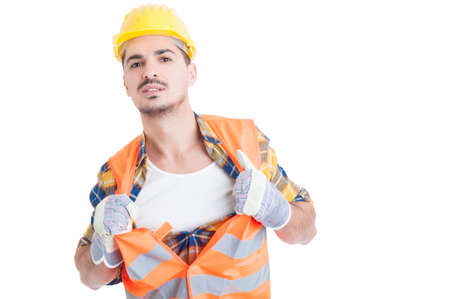 Handsome engineer acting like a super hero in his workwear while holding his shirt and vest isolated on white backgroundの写真素材