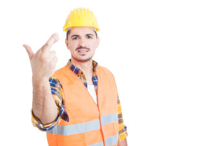 Young handsome constructor or engineer holding crossed fingers and smile as good luck or wish gesture concept with copypaste on white studio backgroundの写真素材