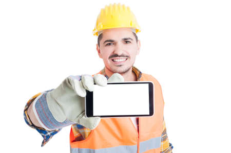 Joyful engineer holding a cell phone with blank screen with copy space on white studio backgroundの写真素材