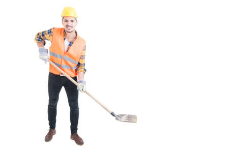 Happy engineer holding a shovel as digging concept with copy space isolated on white backgroundの写真素材