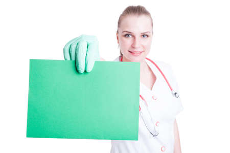 Portrait of attractive happy doctor with a blank or empty banner in close-up isolated on white backgroundの写真素材