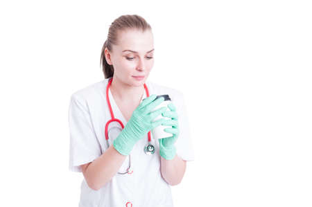 Young woman doctor having a break and drinking coffee as relaxation concept isolated on white backgroundの写真素材