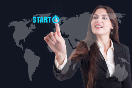 Business woman pressing start button on digital transparent screen as worldwide connections system...