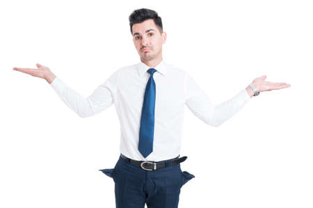 Broke salesman showing empty pants pockets as bankruptcy concept isolated on white backgroundの写真素材