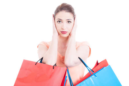 Woman carrying shopping bags making deaf gesture isolated on white background with copy text spaceの写真素材