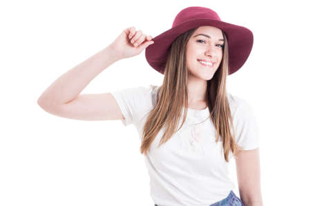 Portrait of trendy happy female with big hat smiling and posing confident isolated on white backgroundの写真素材