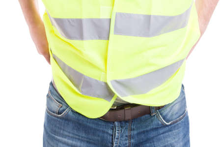 Man constructor in blue jeans wearing reflective safety vest in close-up isolated on white studio backgroundの写真素材