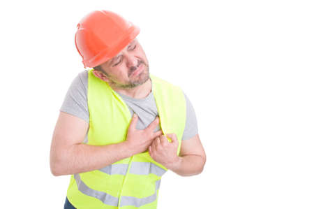 Sick young constructor having painful heart attack as cardiovascular problems concept isolated on white background with copy spaceの写真素材