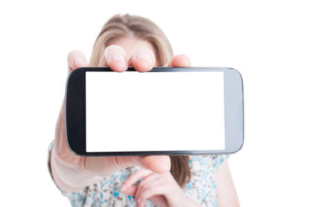 Shopper female with shopping bags showing blank smartphone screen with copy space area isolated on...