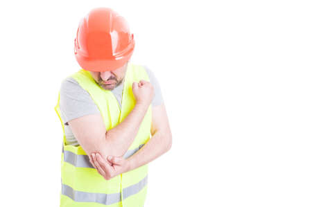 Body injury concept with young foreman holding his elbow with problem isolated on white background...