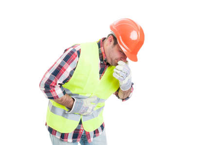 Builder with stomach problem is about to vomit as nausea and sickness concept isolated on white backgroundの写真素材