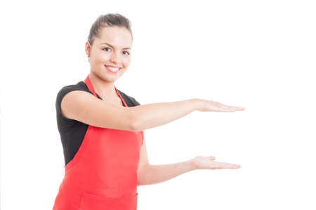 Joyful hypermarket seller holding something small and invisible in hands isolated on white...