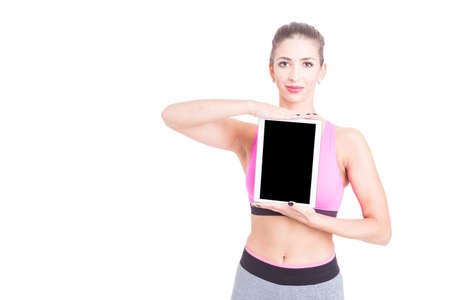 Female holding tablet wearing pink bustier and thighs isolated on white with copy text spaceの写真素材