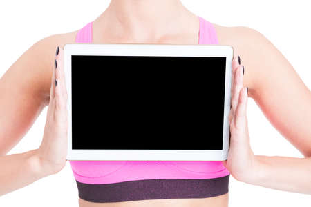 Close-up woman wearing pink bustier holding tablet with black screen isolated on white with copy text spaceの写真素材