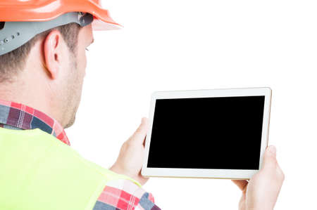 Male builder with digital tablet and empty display isolated on white background with advertising areaの写真素材