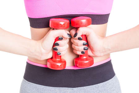 Back view close-up of girl holding dumbbells isolated on white background