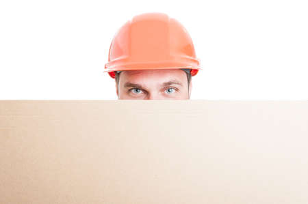 Young builder holding big placard with advertising area isolated on white backgroundの写真素材
