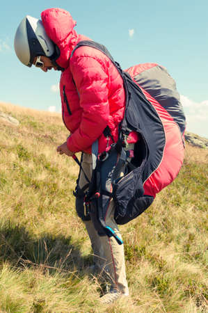 Man paraglider preparing for the next flight on a sunny summer dayの写真素材