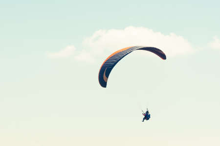 Paraglider enjoying the blue sky or sunny day with copy advertising areaの写真素材