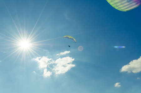 Sun view with two paragliders in the blue sky with copy text spaceの写真素材