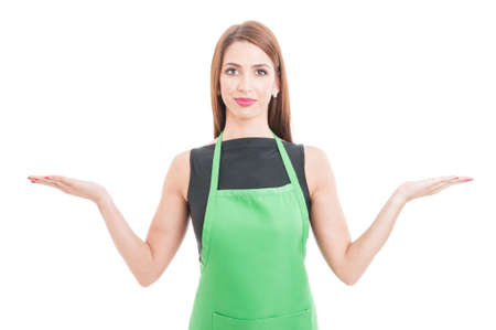 Young pretty employee holding something in her palms with copy space isolated on white backgroundの写真素材