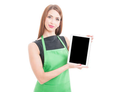 Pretty young employee holding tablet with empty screen and copy space on white backgroundの写真素材