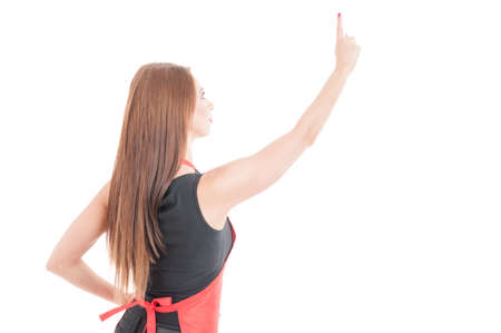Female clerk pointing finger up on invisible screen as futuristic technology concept isolated on white backgroundの写真素材