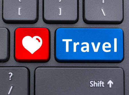 Travel and heart symbol text buttons on keyboard as love to travel or online reservations conceptの写真素材