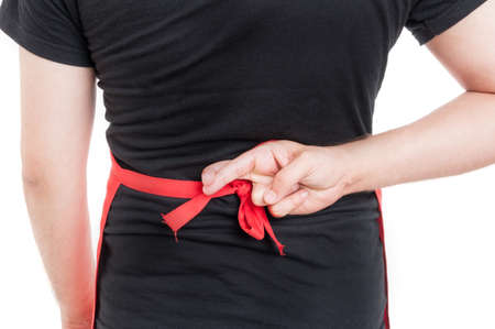 Close-up of male butcher doing luck gesture behind his back isolated on white backgroundの写真素材