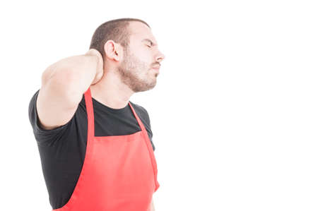Young supermarket seller having neck pain as medical problem concept isolated on white background with copy spaceの写真素材
