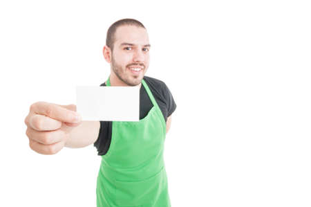 Selective focus of supermarket young employee showing business card isolated on white background...