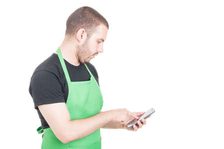 Hypermarket seller texting on smartphone isolated on white background with advertising area
