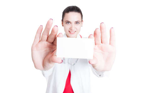 Attractive female medic holding blank visit card as medical services concept isolated on white