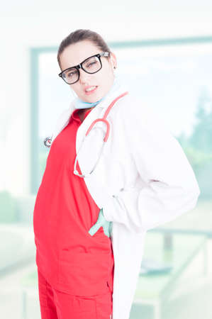 Tired young medic with back problems as body injury conceptの写真素材