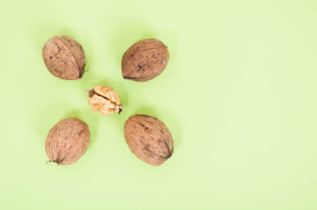 Closeup of nuts and kernel isolated on green background with text spaceの写真素材