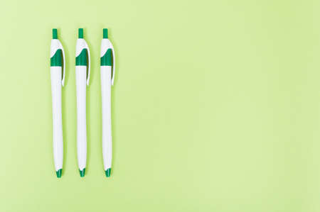 Closeup of three pencils with text area isolated on green background as writing conceptの写真素材