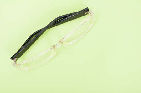 One pair of sight glasses on green background with copy text area
