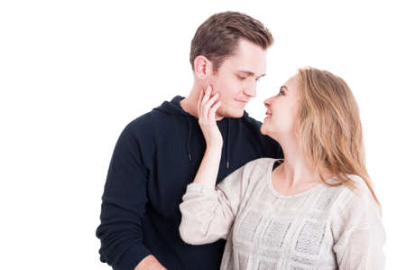 Pretty couple wearing casual fall clothes looking at each other and smiling isolated on white background with copy text spaceの写真素材