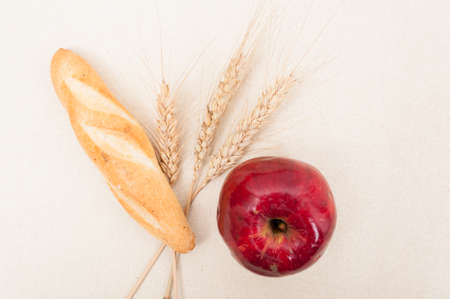 Fresh and wholesome meal concept with homemade loaf or baguette and appleの写真素材